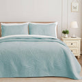 Lightweight aqua blue quilt set with leaf-pattern ultrasonic embossed texture and matching shams
