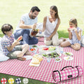Pink and white check waterproof picnic blanket, folded roll with carry strap