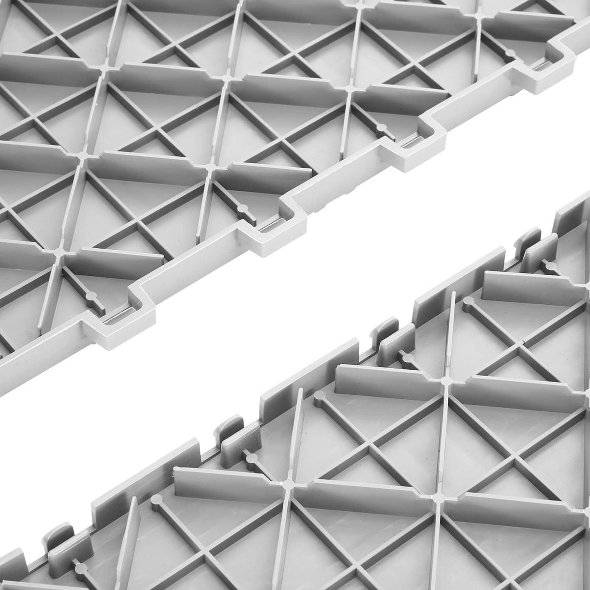 Silver interlocking garage tile edge detail with snap tabs and raised support grid