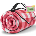 Rolled red-and-white check picnic blanket with carry straps and buckled handle