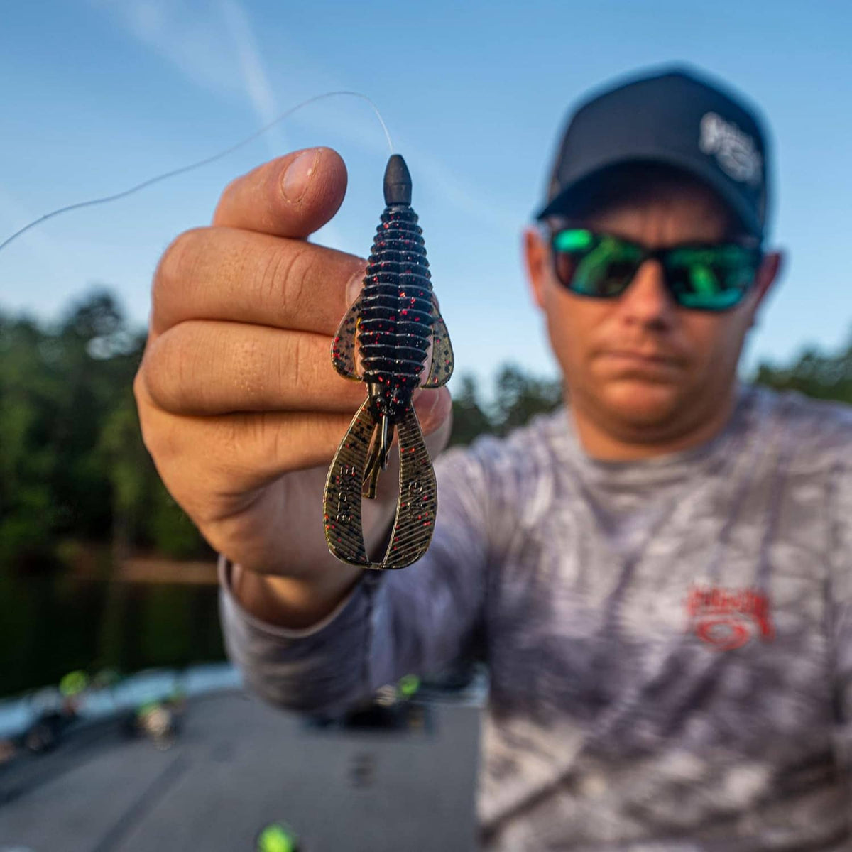 Fishing lure with split-tail twin treble hooks, dark blue and chartreuse body