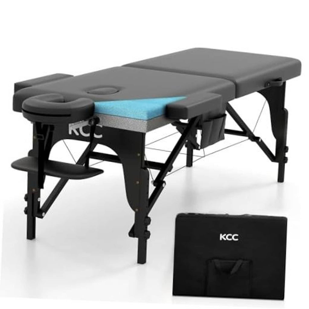 Portable massage table with dark gray upholstery, round headrest cushion, black folding legs