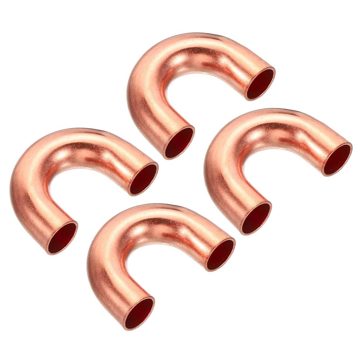 Four copper elbow pipe fittings, U-bend style with flared end openings
