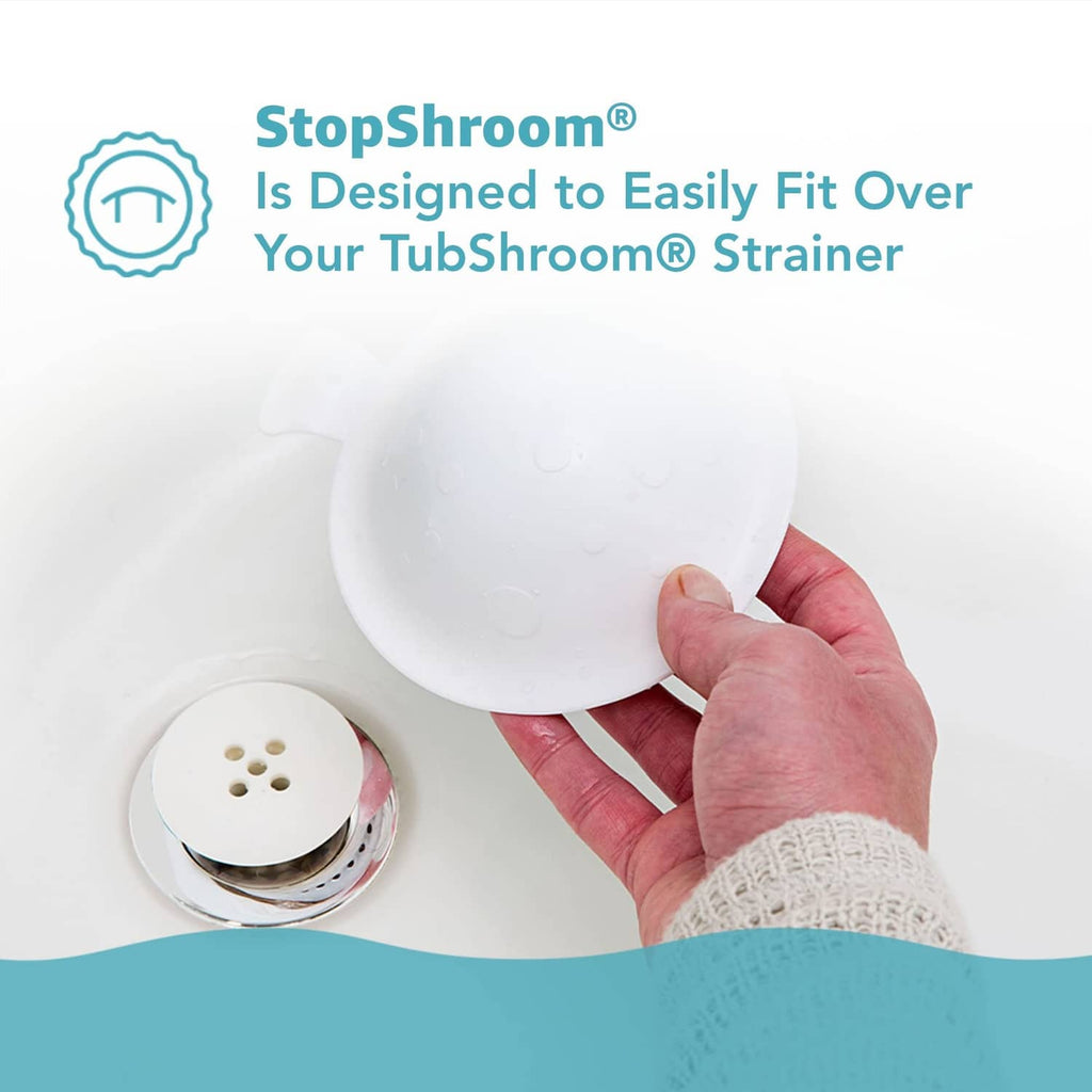 White silicone drain stopper plug being pressed onto tub drain