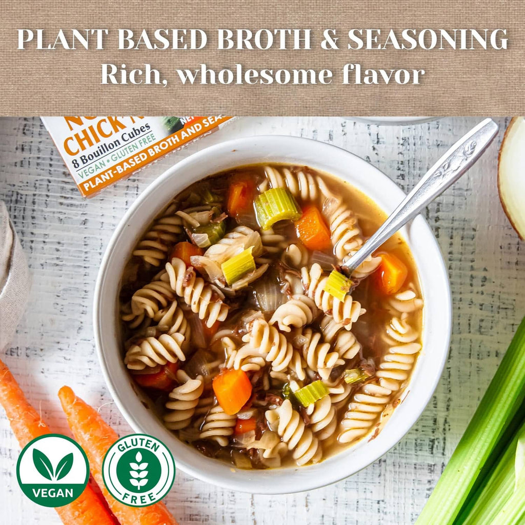 Bowl of noodle soup with carrots and celery, served with plant-based broth seasoning
