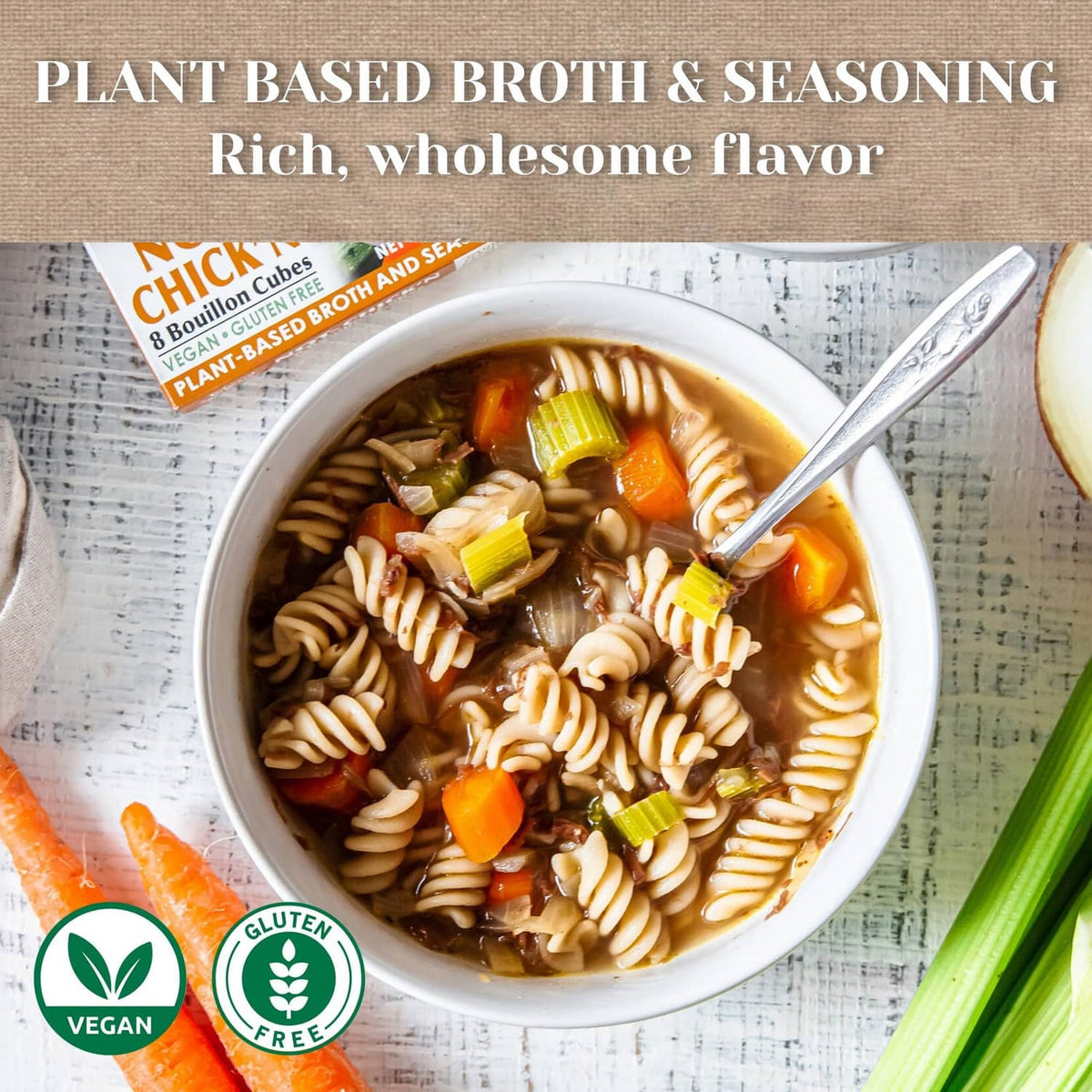 Bowl of noodle soup with carrots and celery, served with plant-based broth seasoning