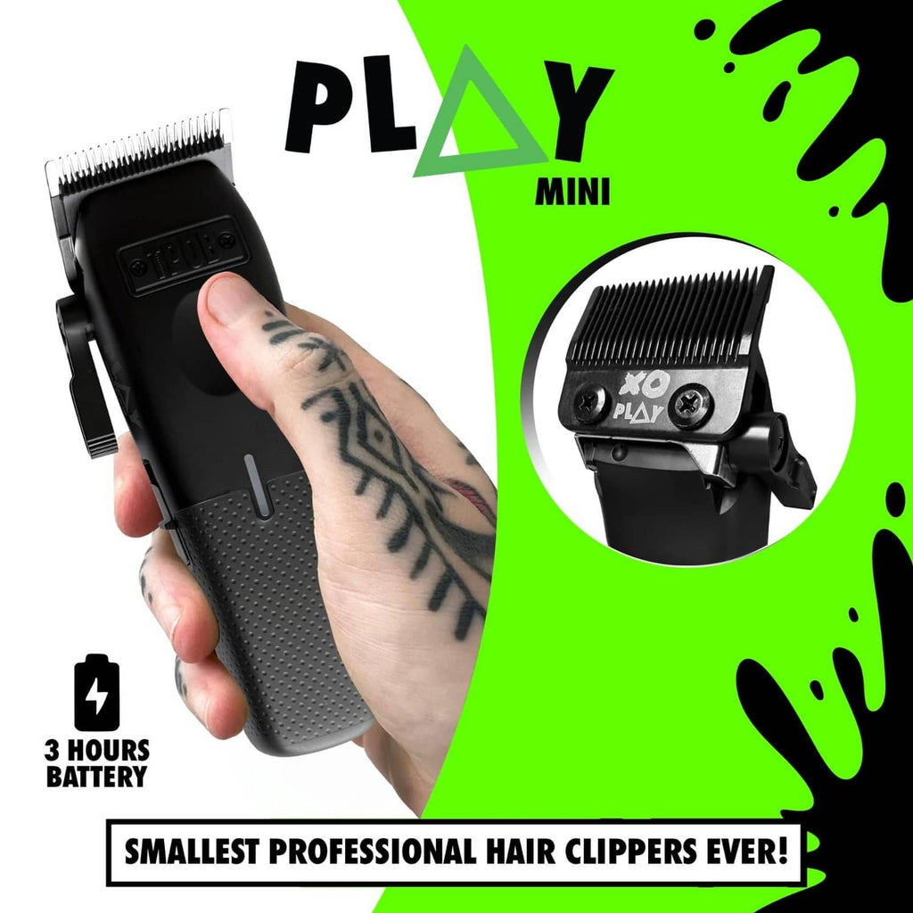 Black mini hair clipper held in hand, with side lever and textured grip
