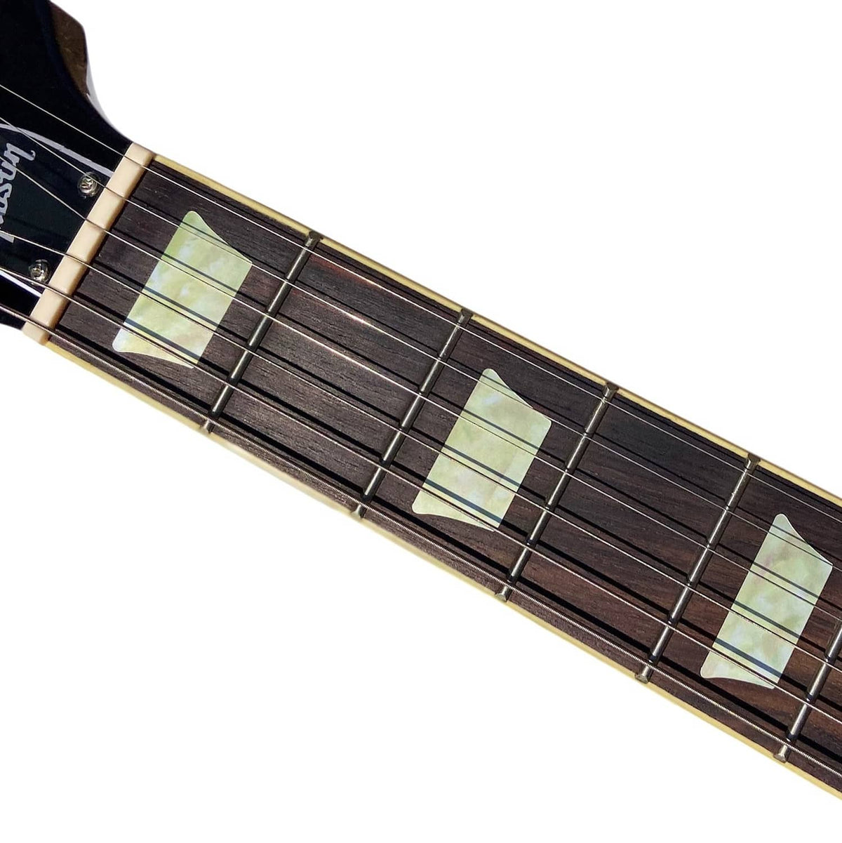 Guitar fretboard close-up with pale rectangular inlay stickers on dark wood