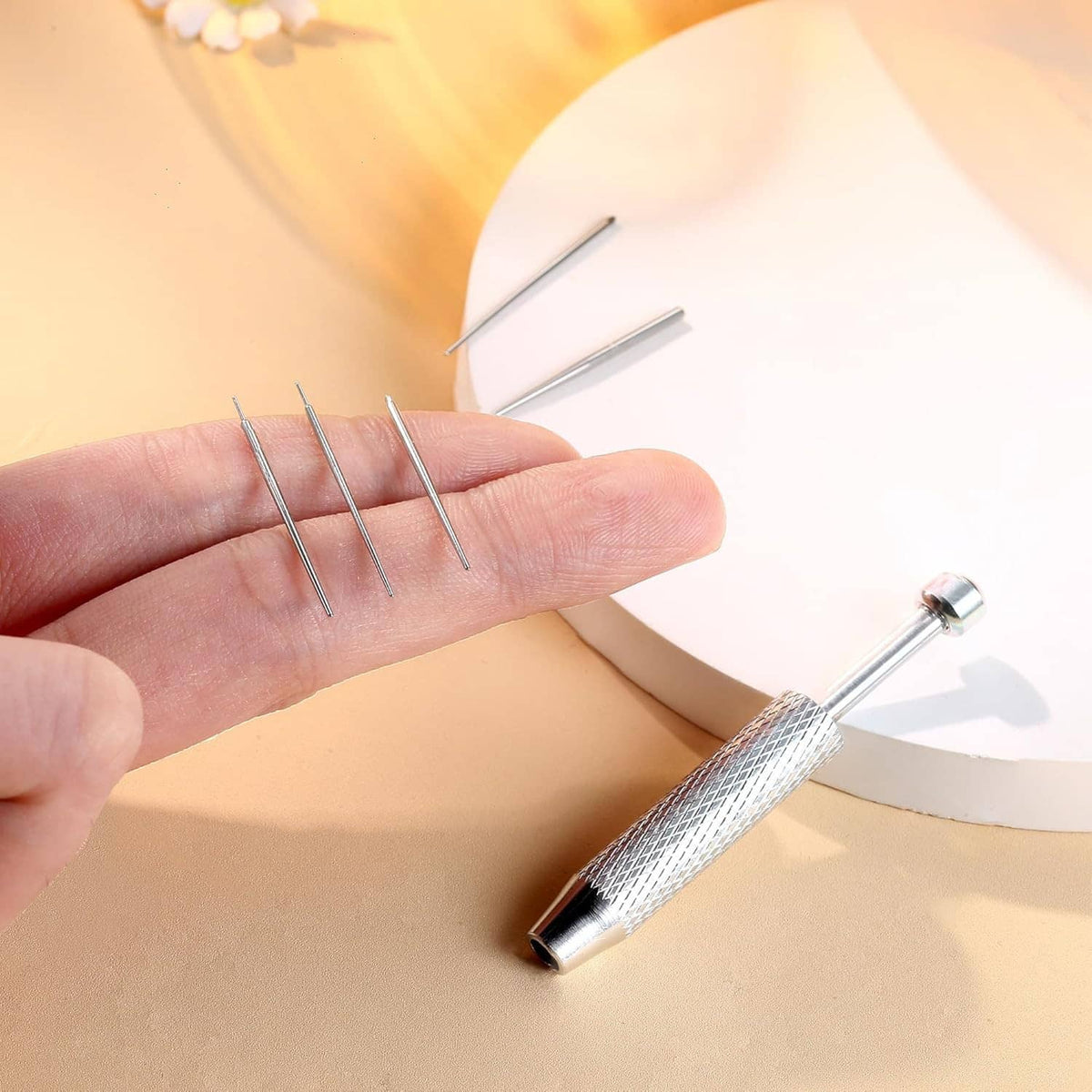 Stainless steel piercing ball grabber tool with textured grip and taper prongs