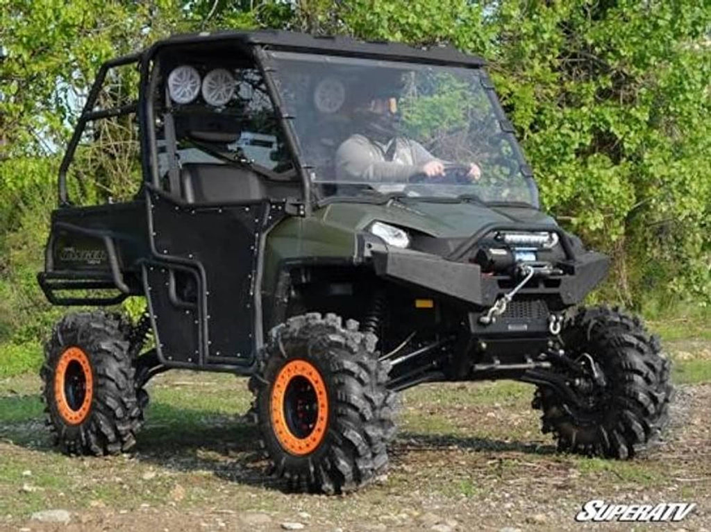 Front-left side view of clear full windshield on green UTV with black frame