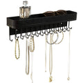 Black wall-mounted necklace organizer with hanging hooks and long top bar tray