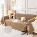 Brown waterproof couch cover draped on sofa with cat, splash-protecting front