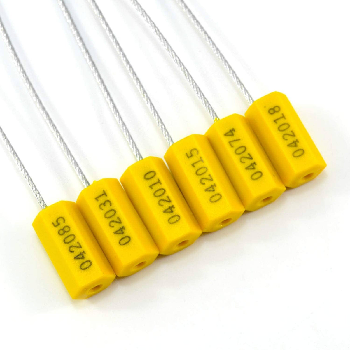 Close-up of yellow cable seal blocks with steel wire and printed serial text
