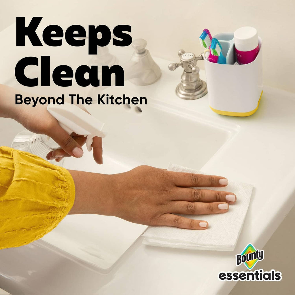 White paper towel sheets in hands, stacked and ready for cleaning messes