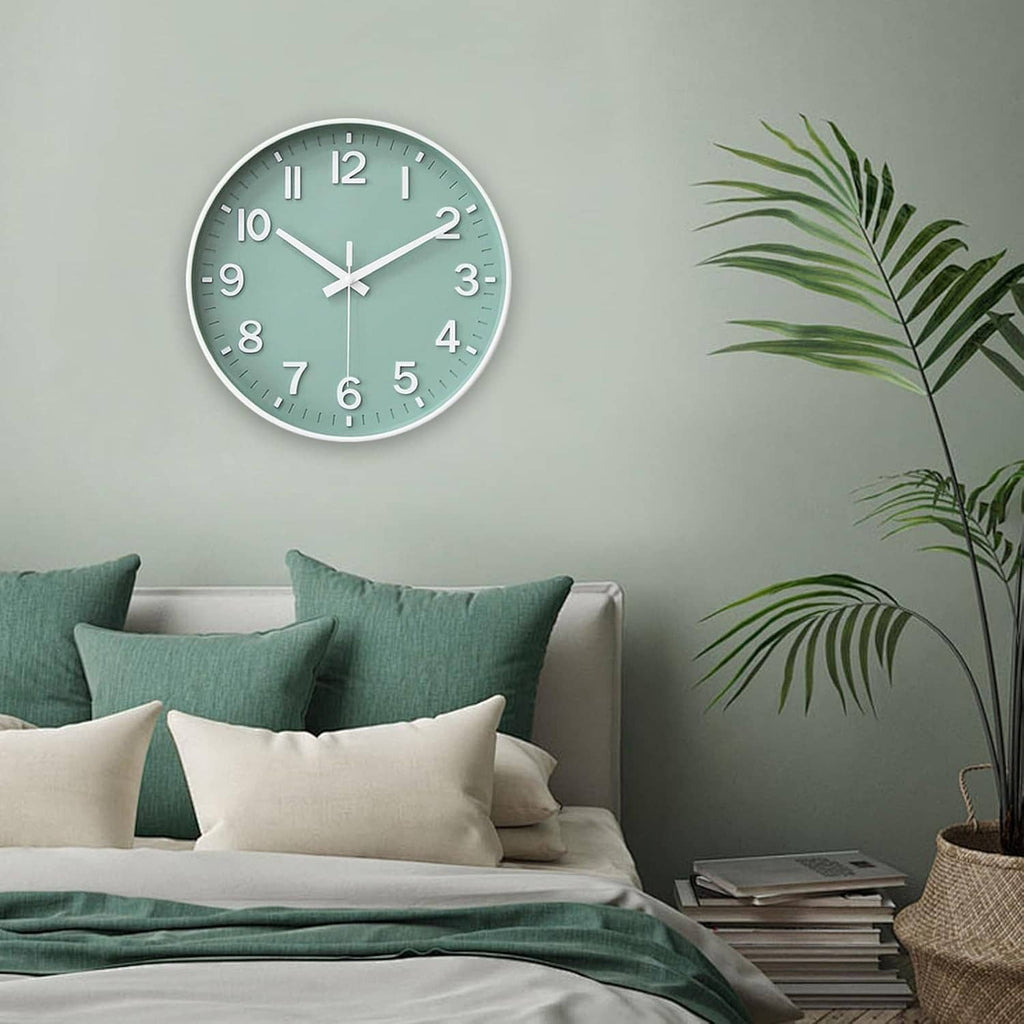 Green round wall clock with white hour markers on a wall above a sofa.