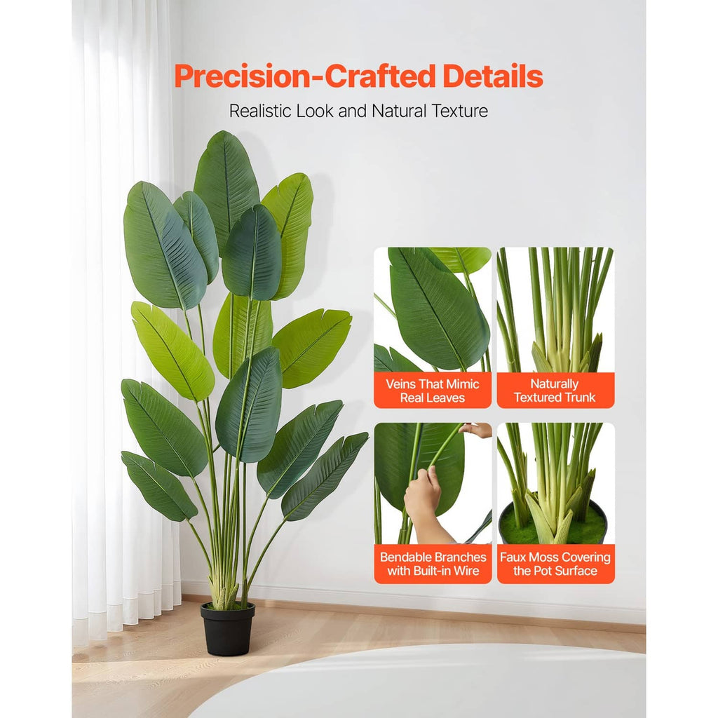 Artificial bird of paradise plant with layered green leaves in a black pot