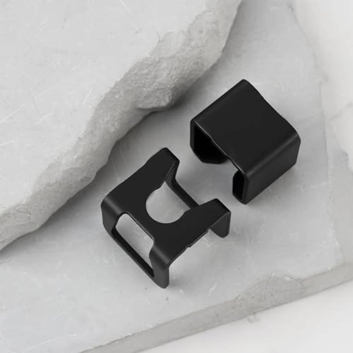 Black jack spare part brackets with open center cutouts, two pieces shown.