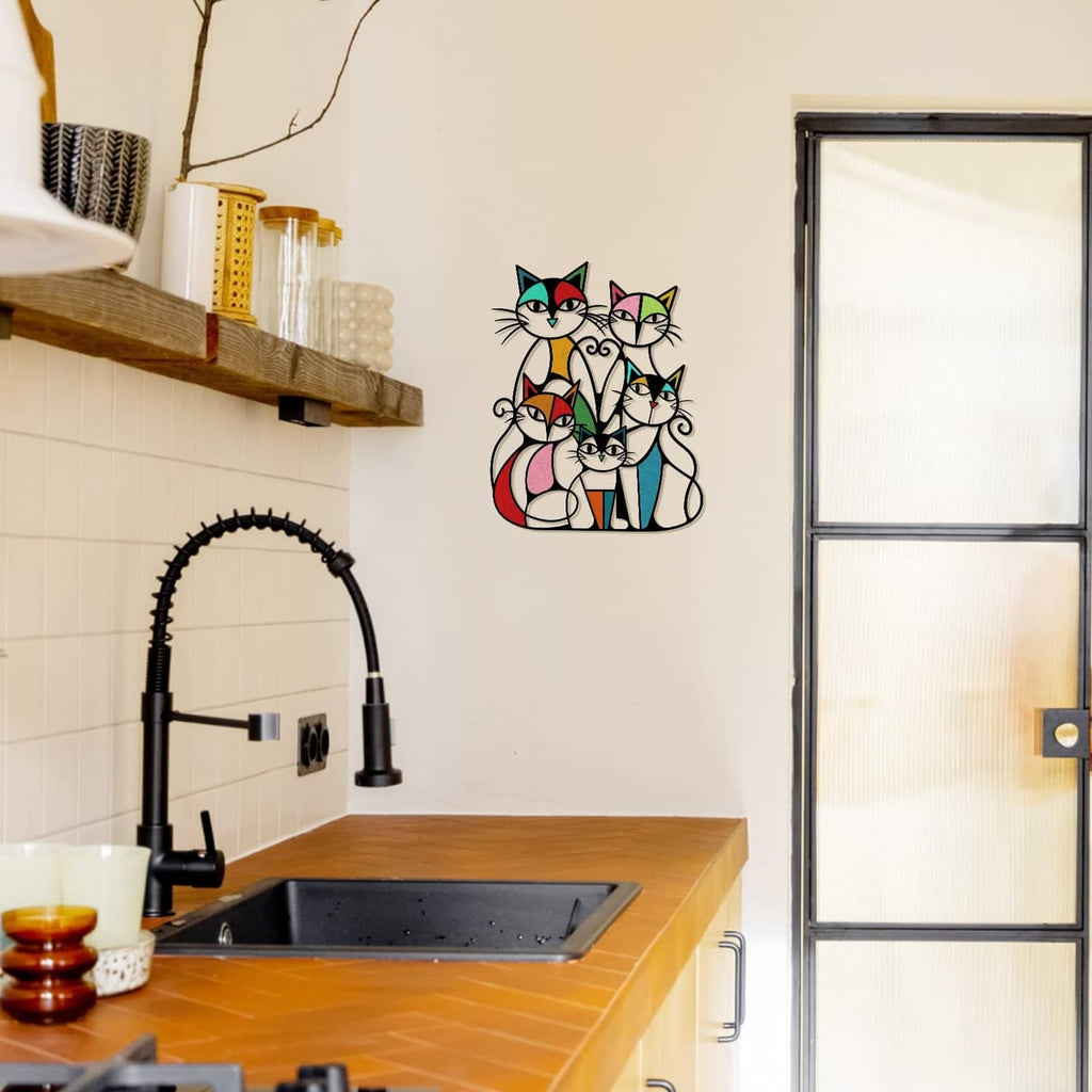 Colorful metal cat wall art with five retro cats mounted above a kitchen sink