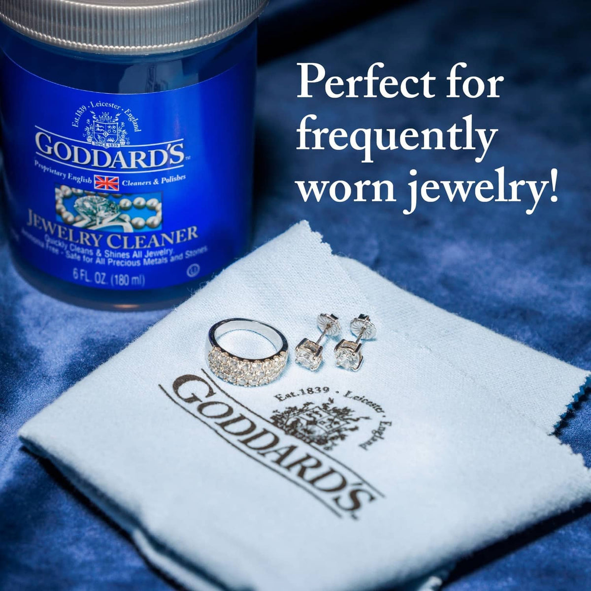 White silver polishing cloth with Goddards logo and small jewelry pieces