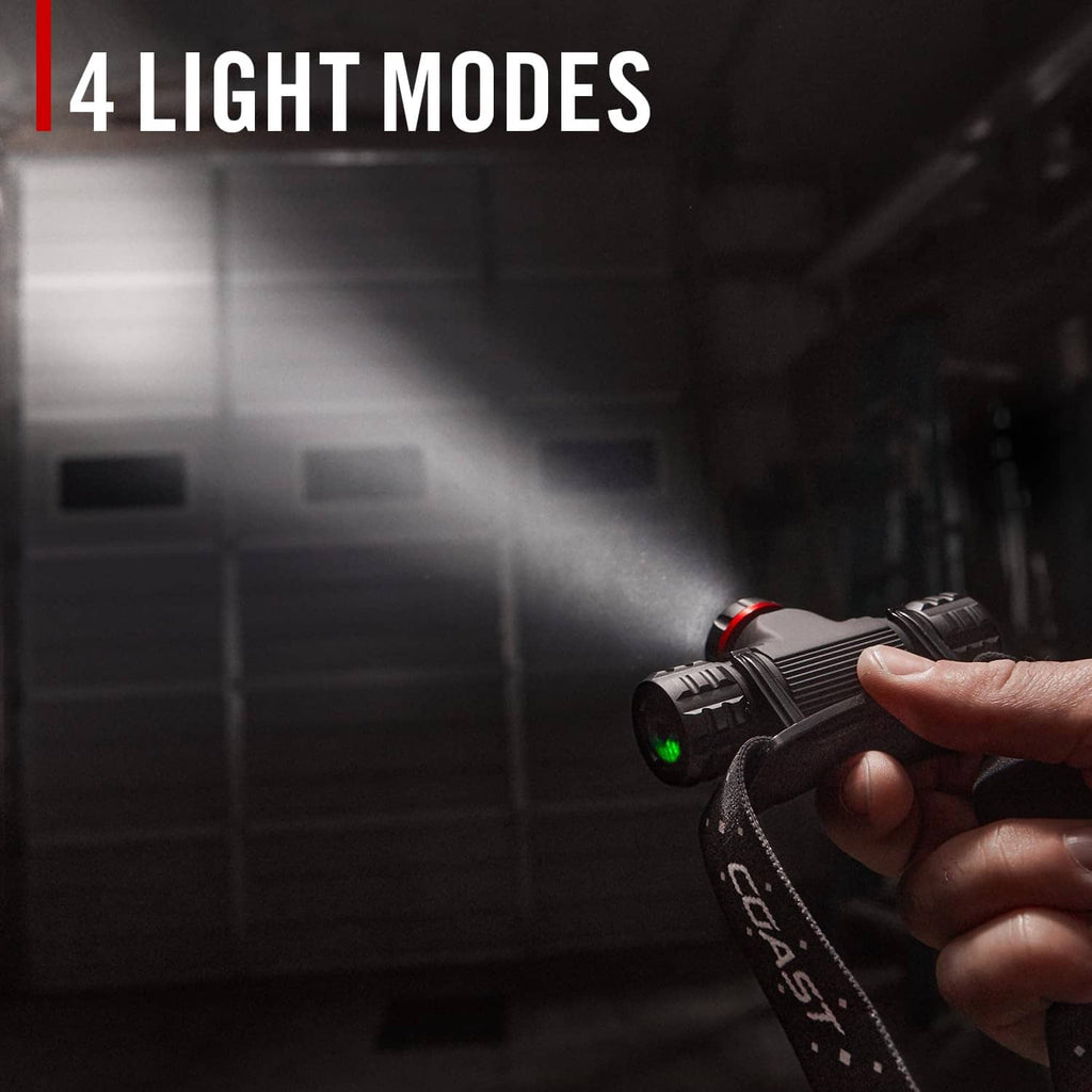 Black headlamp in hand projecting beam from adjustable lens