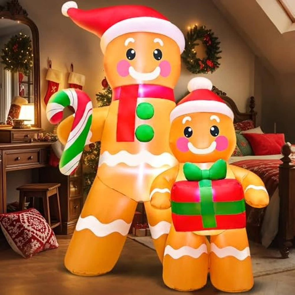 Inflatable gingerbread figures indoors or on a covered porch, red hats, candy cane and gift