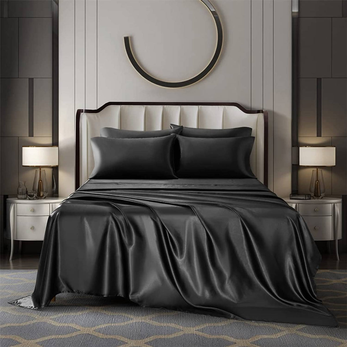 Black satin bedding sheet set on queen bed, with matching pillowcases and flat sheet