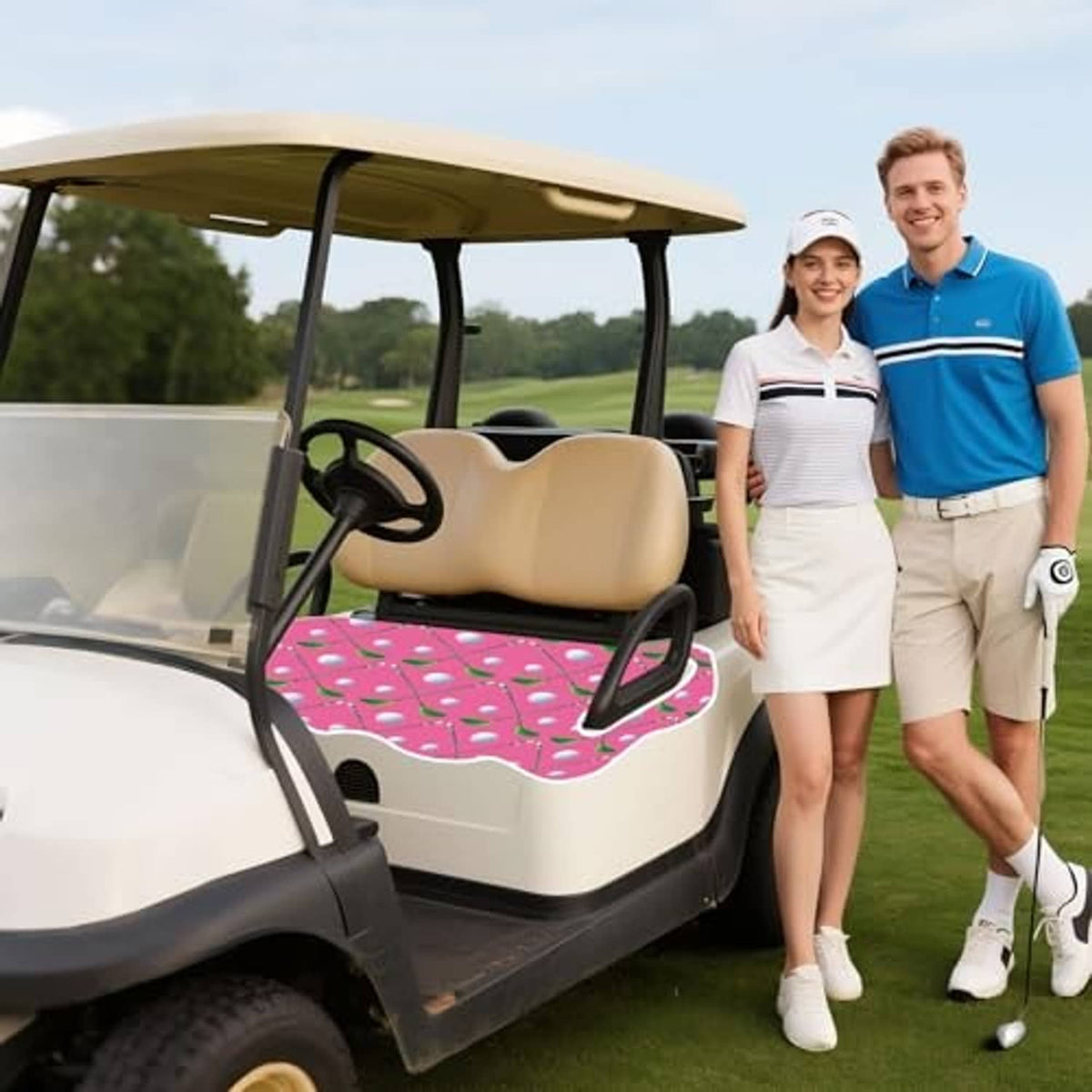 Golf cart with pink leaf-and-dot seat cover on beige cushions outdoors