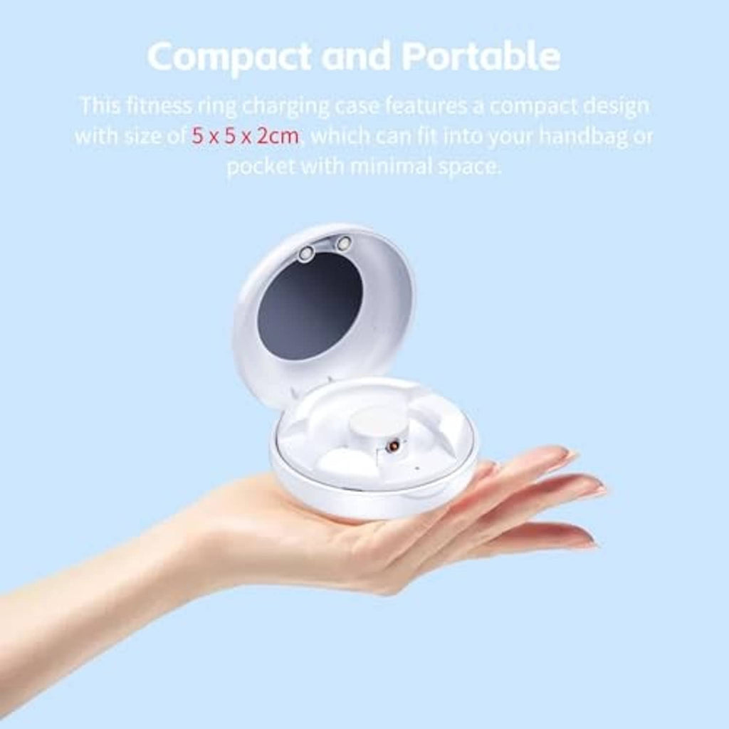 White compact smart ring charging case open, held in hand with cradle inside