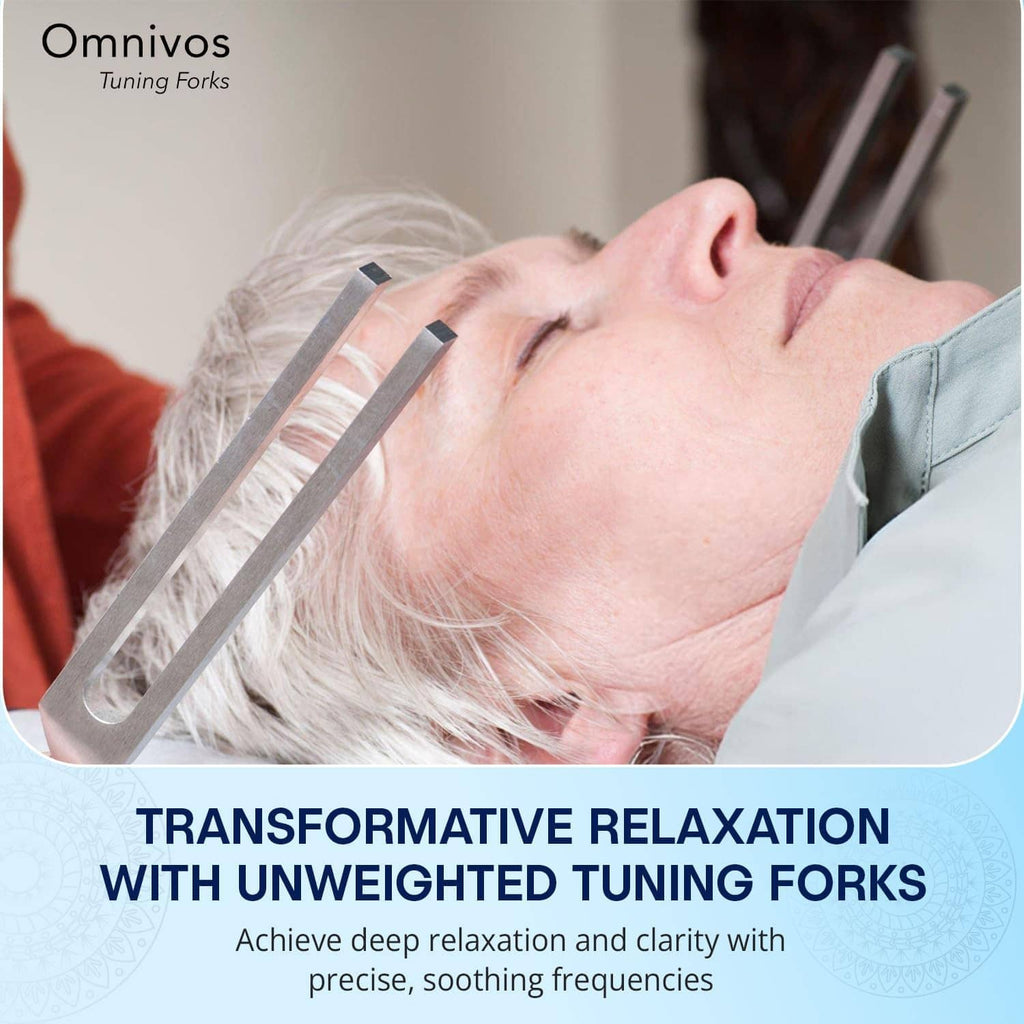 Two silver tuning forks placed near a person's forehead during relaxation