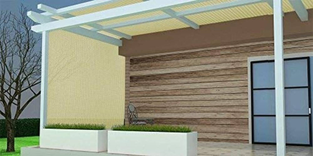 Beige sun shade mesh canopy on pergola-style structure