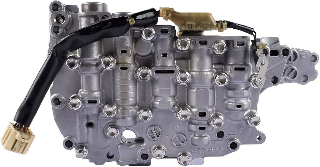 Transmission valve body plate with multiple ports and solenoid housings, silver-gray metal.