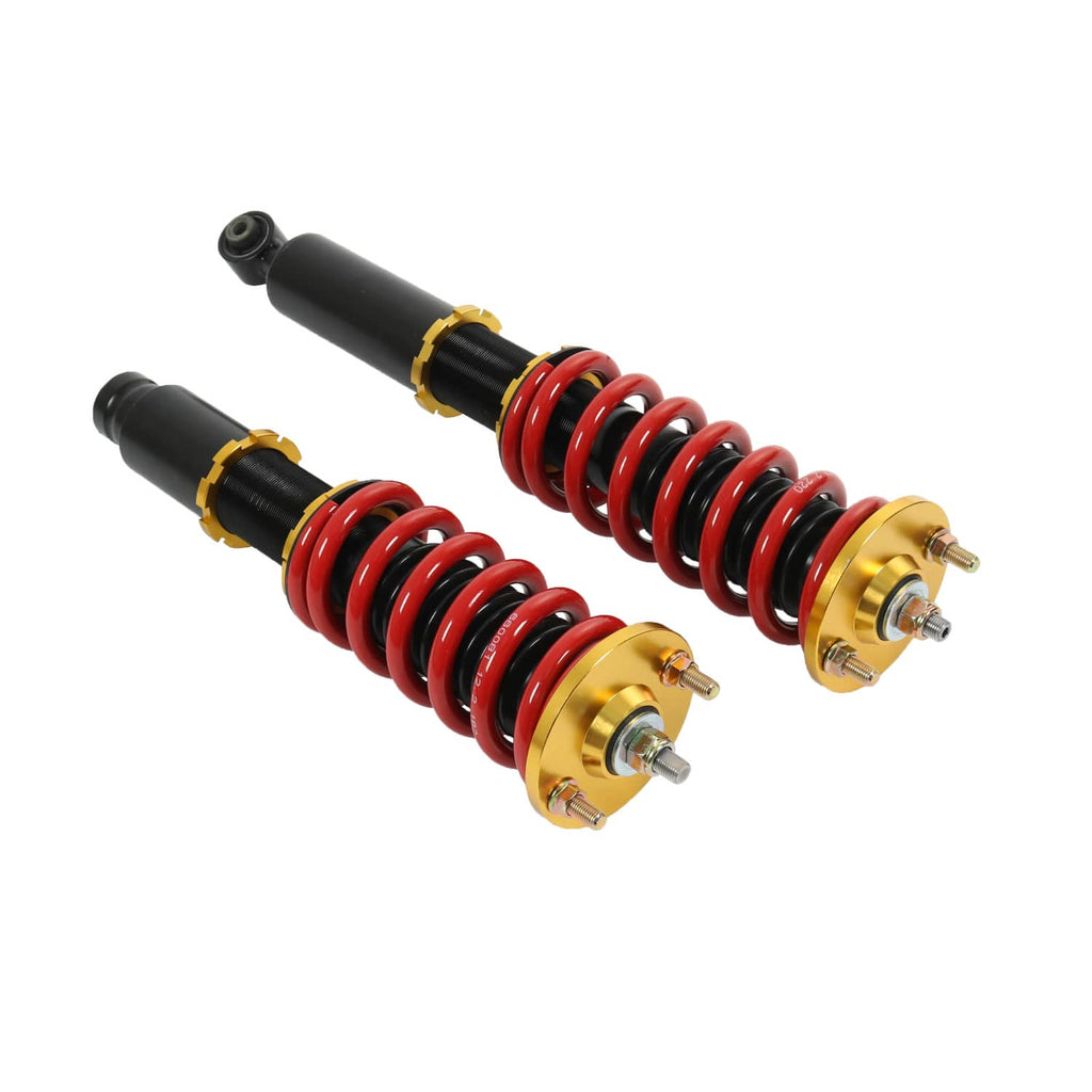 Two coilover shocks with red springs, black cylinders, and gold adjustable collars