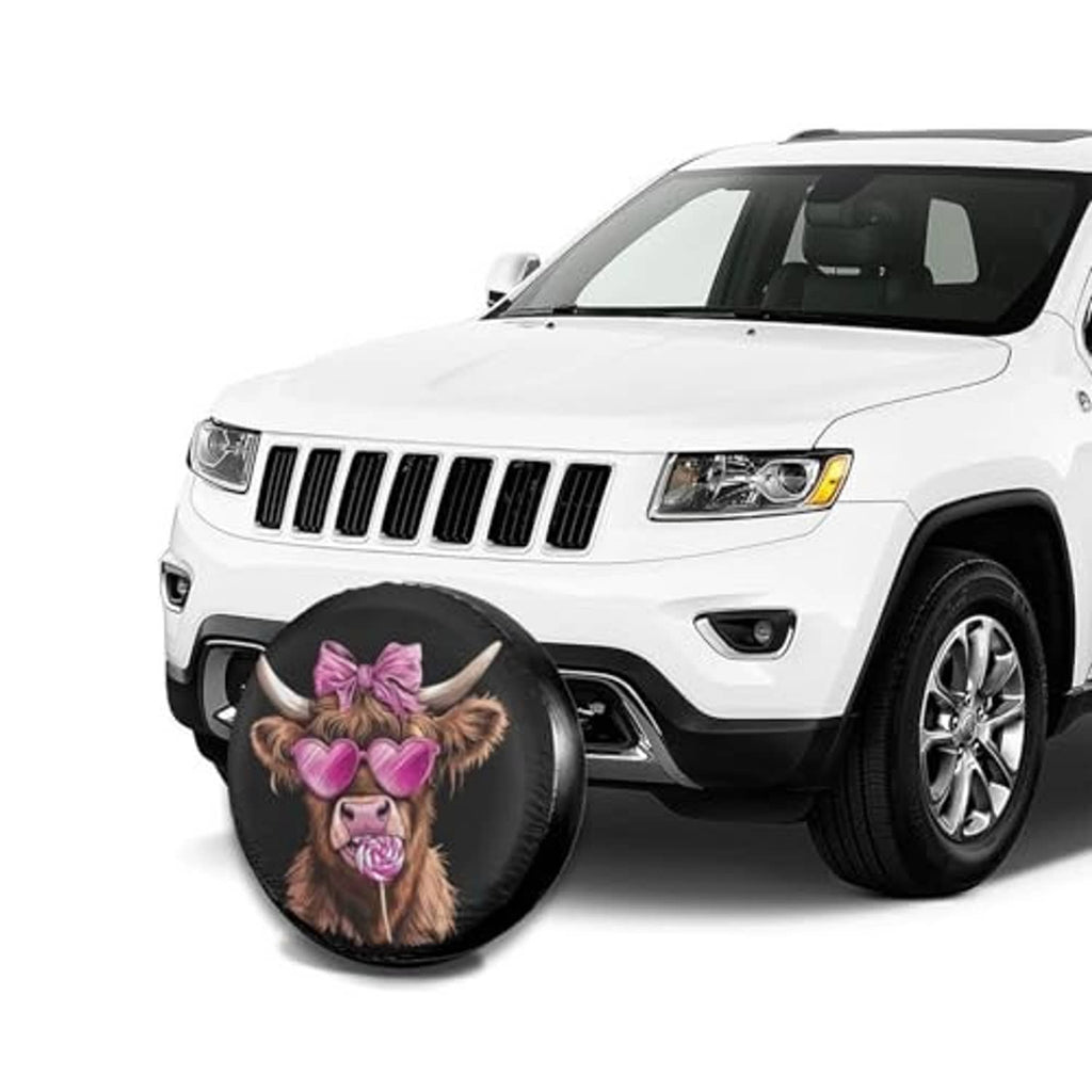 Black round spare tire cover with Highland cow face, pink bow and heart glasses, on front tire