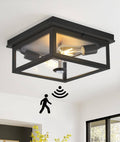 Black outdoor flush-mount ceiling light with exposed bulb and built-in motion sensor.