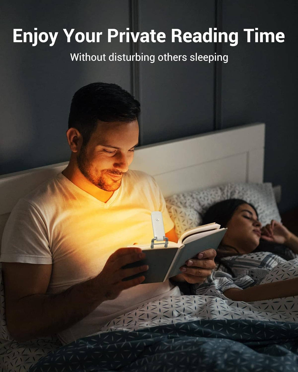 Clip-on LED book light on an open book for nighttime reading in bed