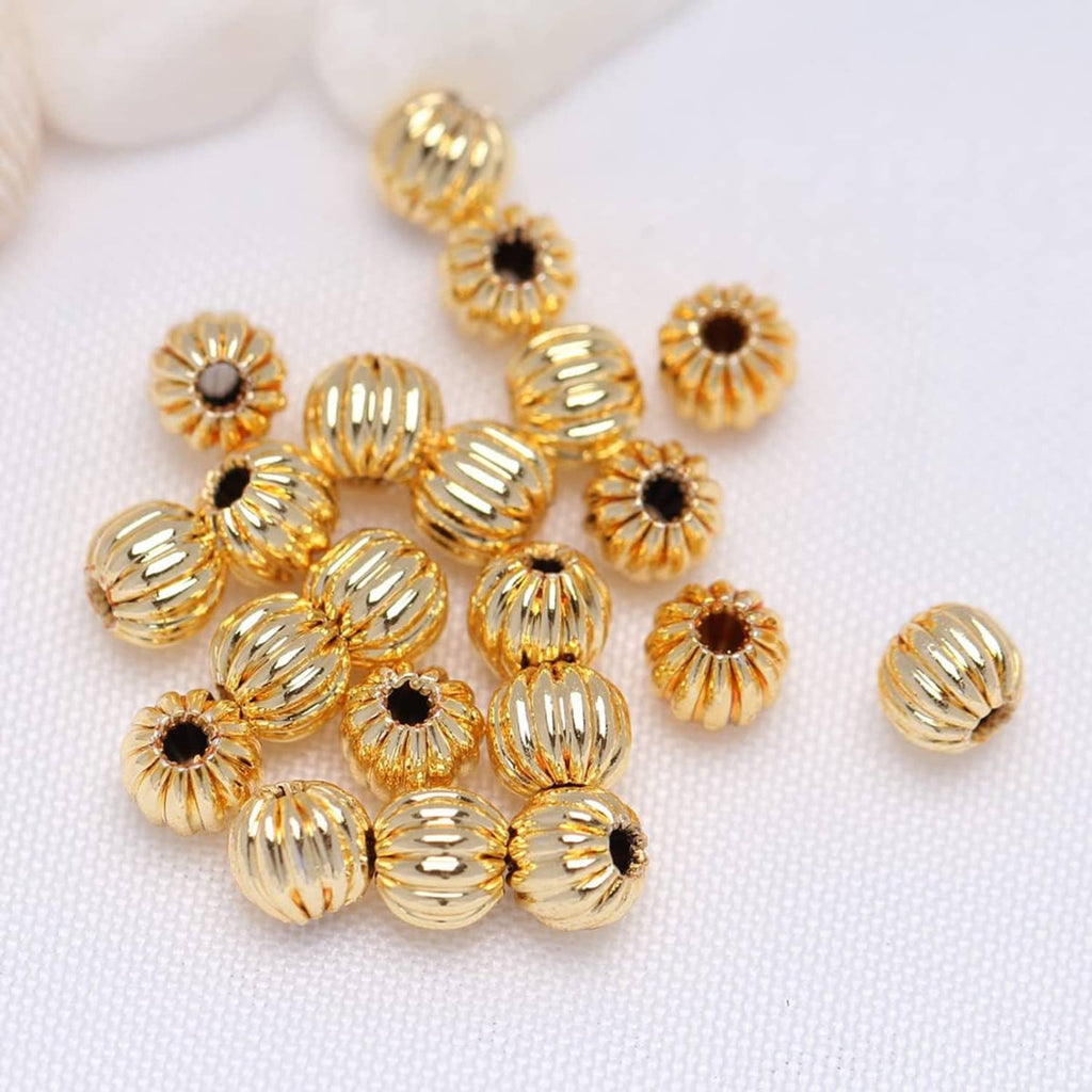 Cluster of gold-tone corrugated round beads with black center dots