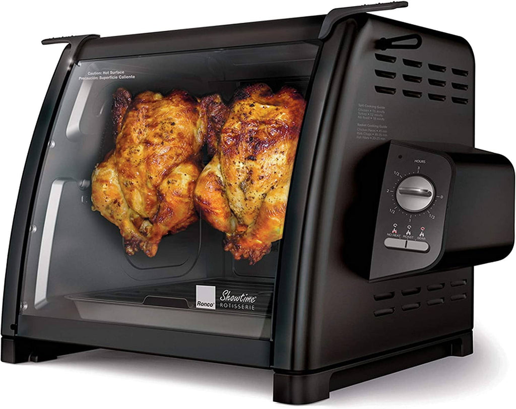 Black countertop rotisserie oven with two roasted chickens inside the glass window