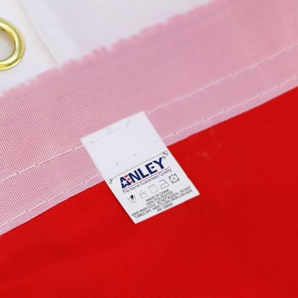 Close-up of ANLEY tag on the canvas header of a red and pink POW/MIA flag