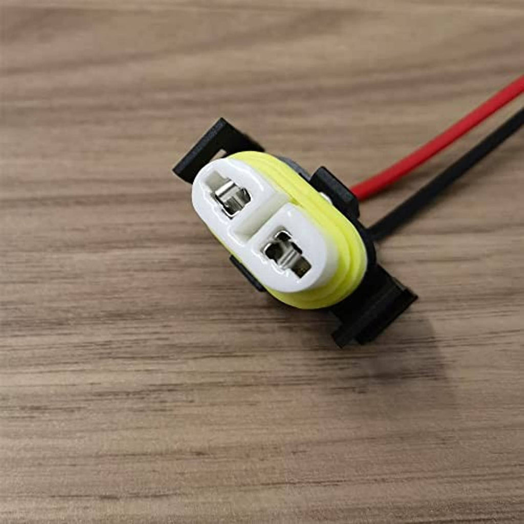 Ceramic socket connector on black bracket, white housing with green insulation ring and terminals