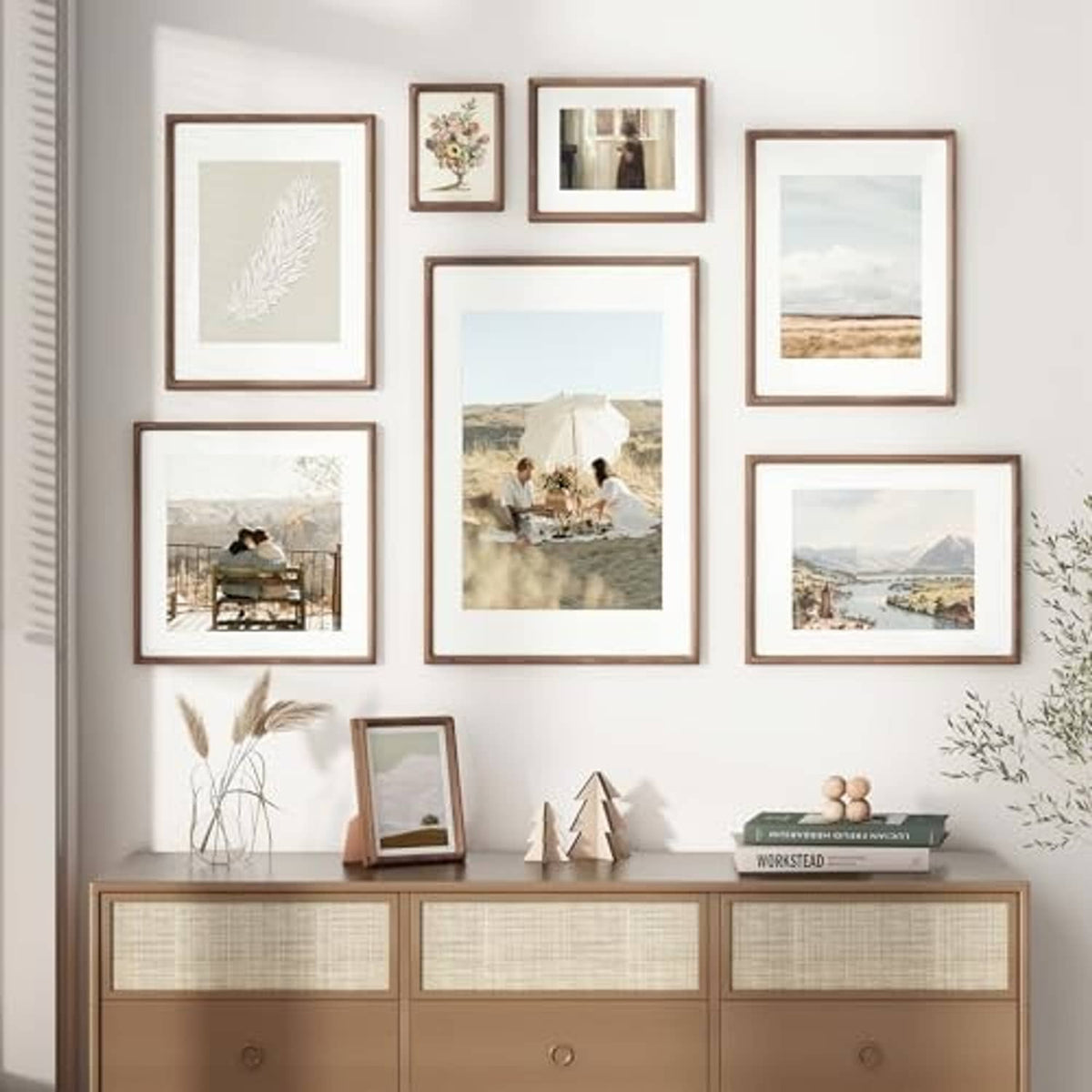 Walnut wood picture frames on wall with white mats, mixed sizes