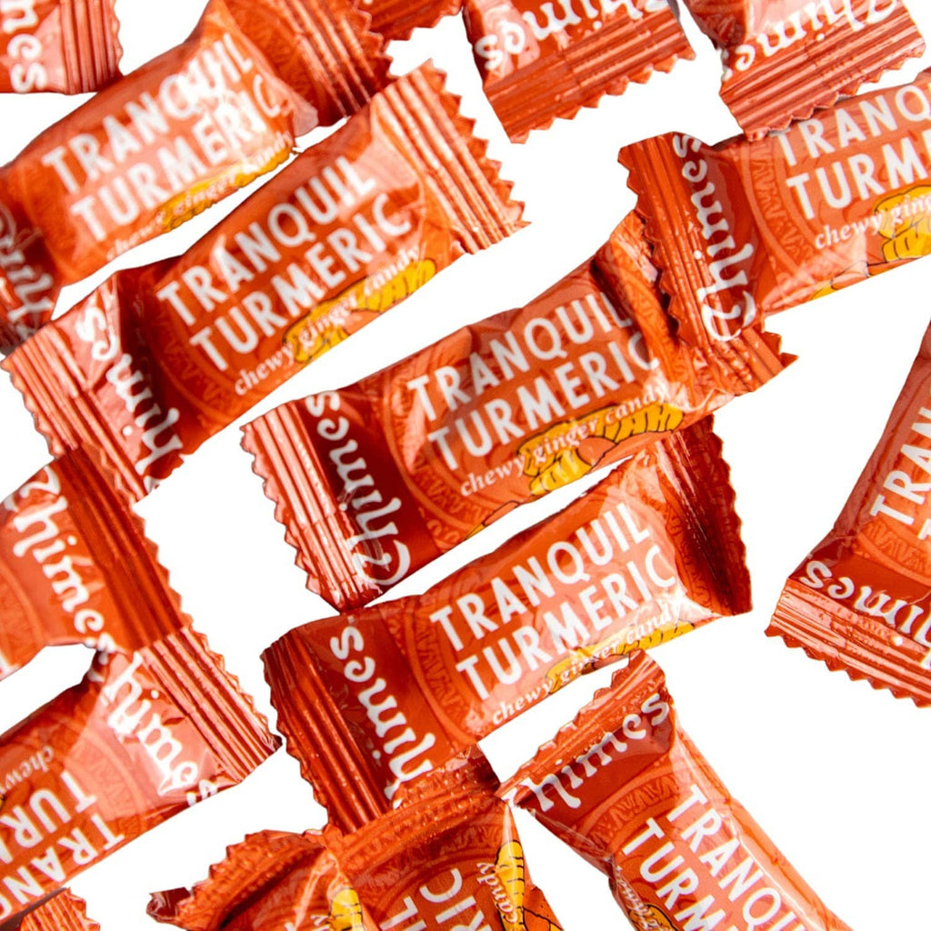 Tranquil turmeric adaptogenic chew candy pieces in orange wrappers