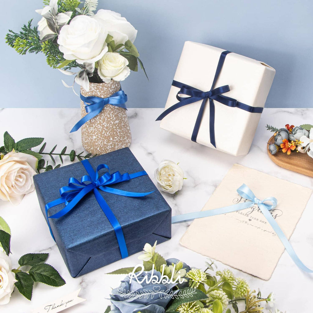 Blue satin ribbon bows on gift boxes with matching ribbon accents