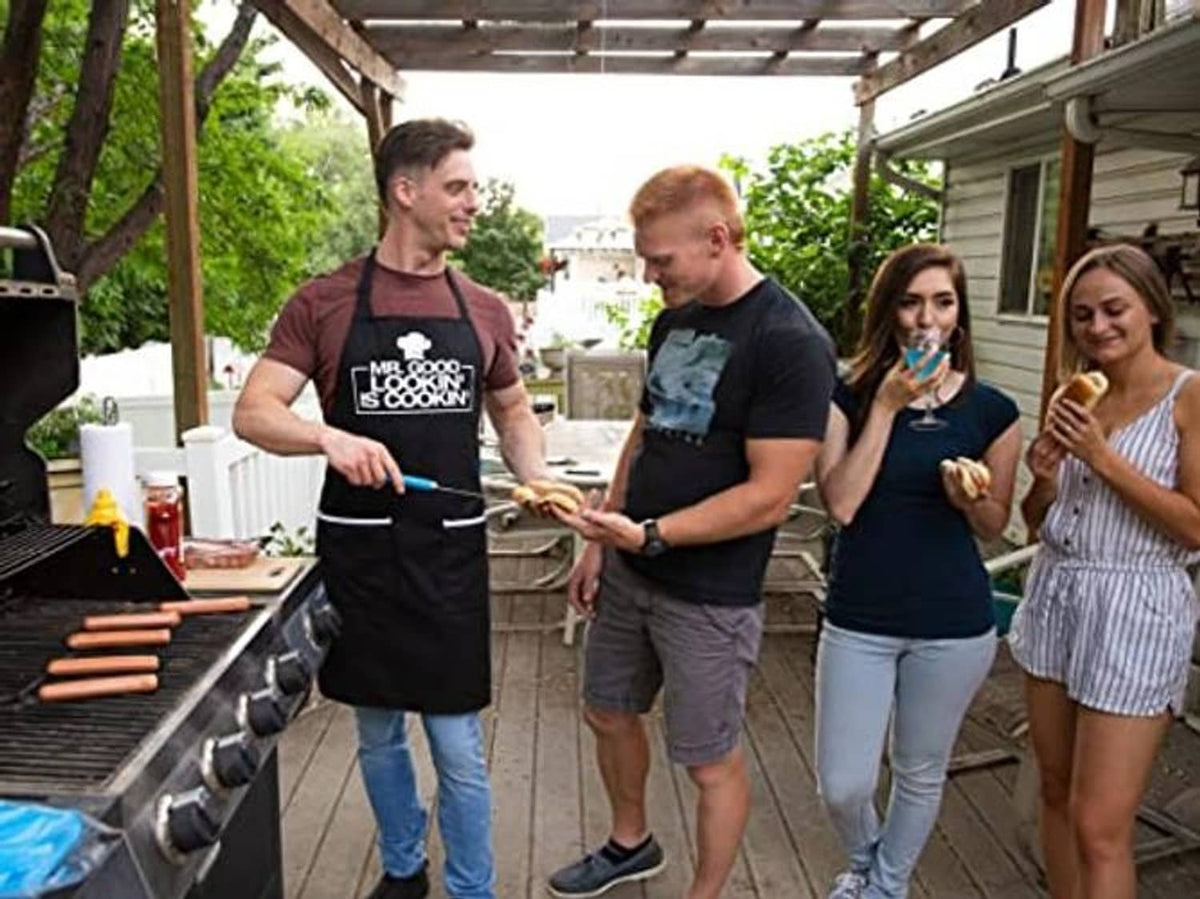 Black apron with chest logo graphic and two pockets, worn over a maroon shirt