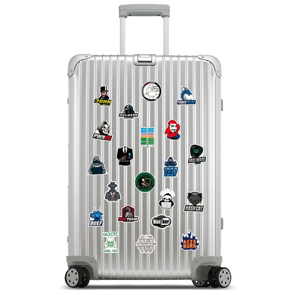 Hacker-themed stickers on a silver rolling suitcase with assorted tech badges