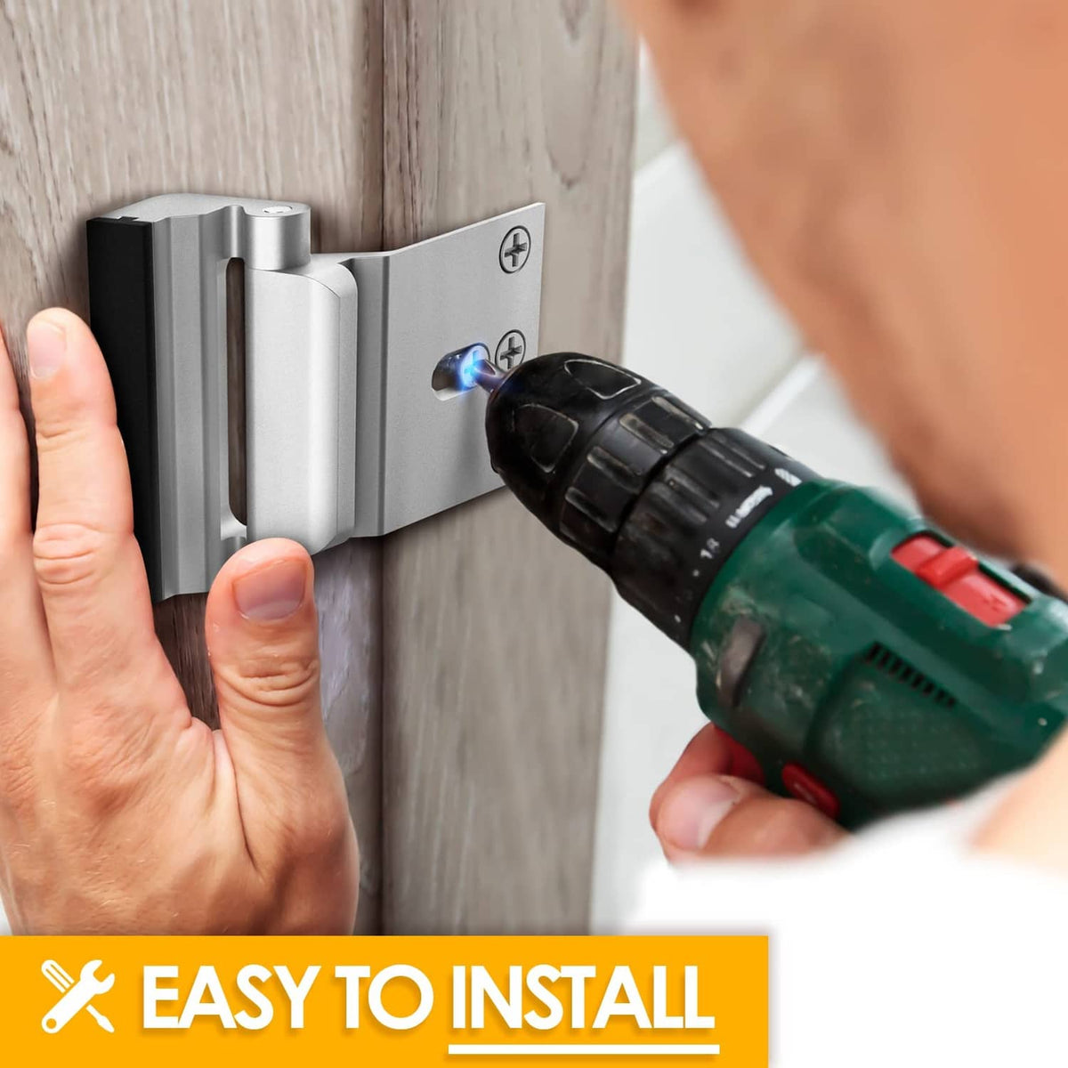 Silver security door lock being installed with a screwdriver