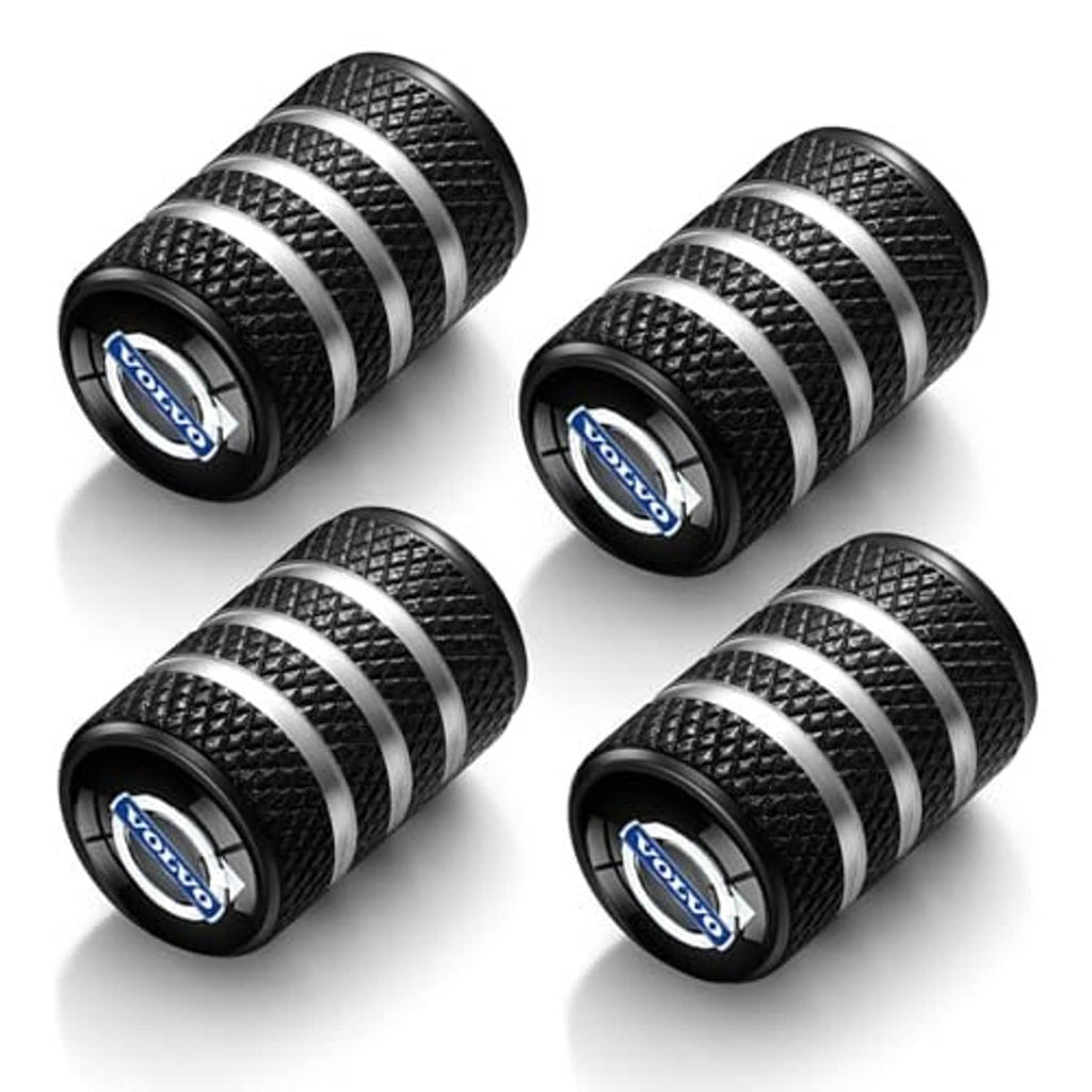 Four black textured tire valve stem caps with silver stripes and blue center logo