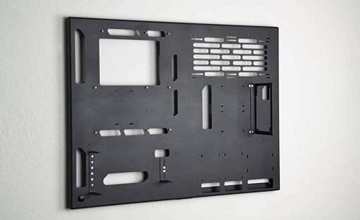 Wall-mounted gaming PC case back panel, black with vent cutouts and mounting holes