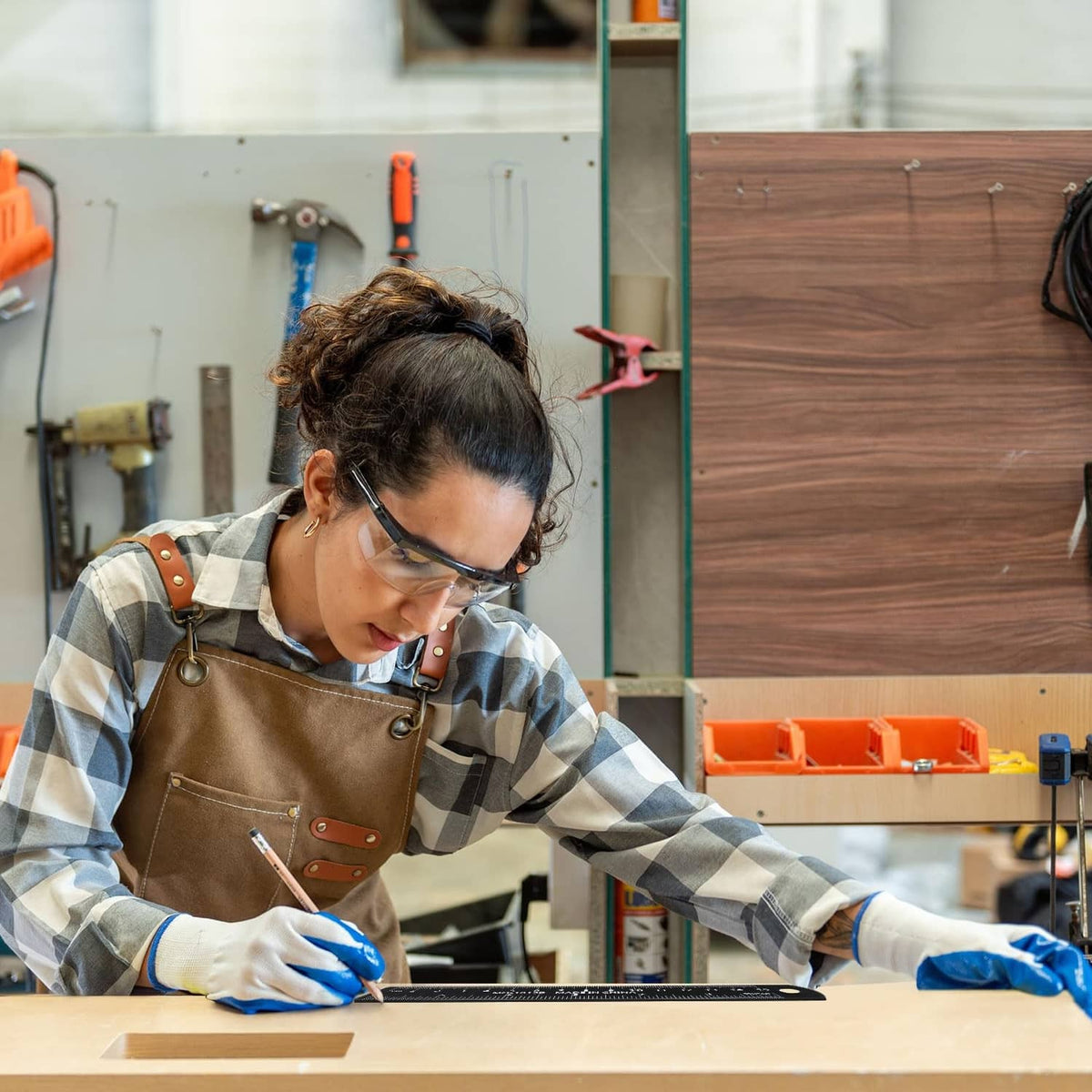 Person using a ruler for measurement on a woodworking workbench