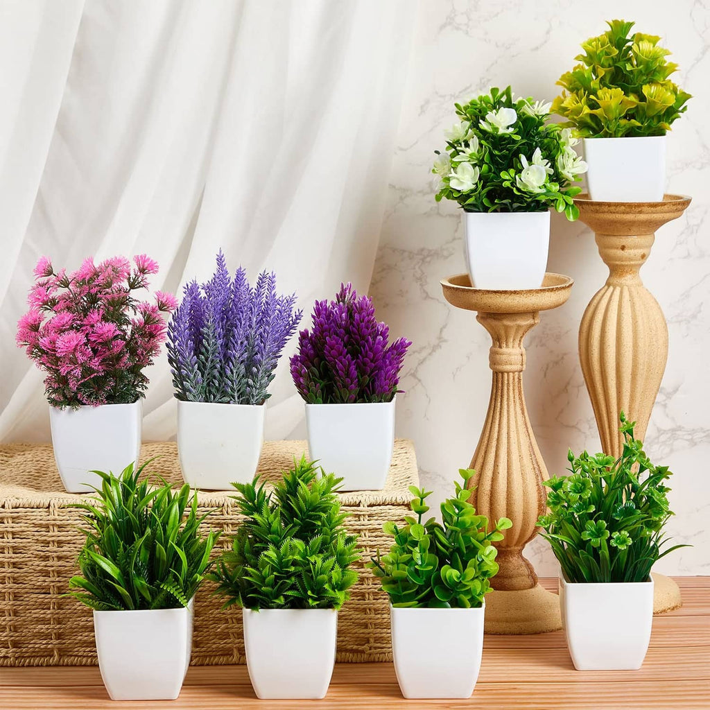 Artificial mini plants set in white pots with mixed green, pink and purple flowers