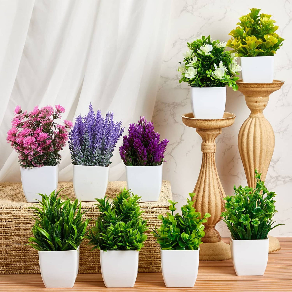 Artificial mini plants set in white pots with mixed green, pink and purple flowers
